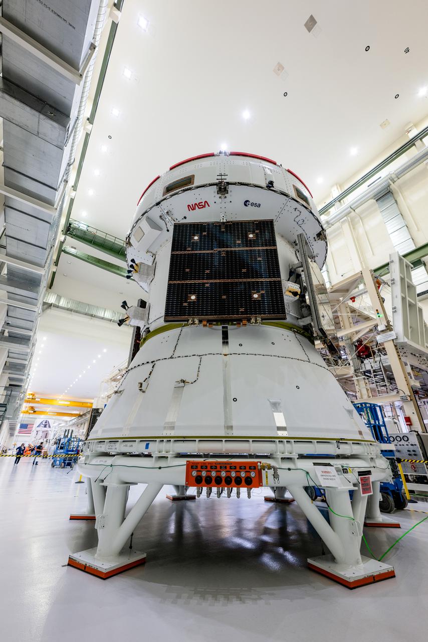 In the Operations and Checkout Building (O&amp;C) at Kennedy Space Center, three spacecraft adapter jettison (SAJ) fairings are prepared for installation and will be moved into place by technicians with Lockheed Martin, lead contractor for Orion on Oct. 12, 2020. They will be secured around the spacecraft, encapsulating the European Service Module to protect it from the harsh environment as the spacecraft is propelled out of Earth’s atmosphere atop the Space Launch System (SLS) rocket during NASA’s Artemis I mission. The next time the solar array wings will be visible will be when Orion is in space. Artemis I will test the Orion spacecraft and SLS as an integrated system ahead of crewed flights to the Moon.