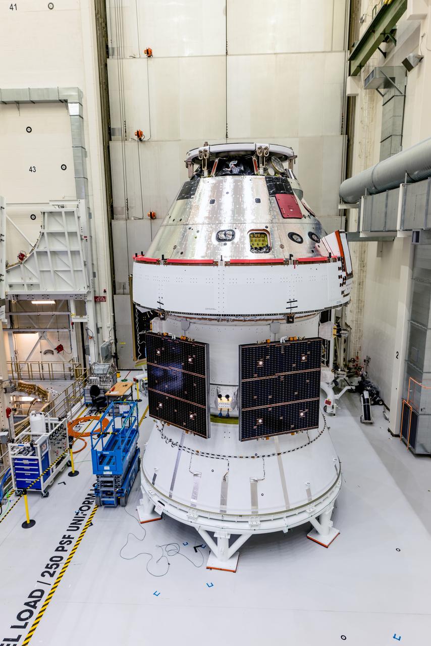 In the Operations and Checkout Building (O&amp;C) at Kennedy Space Center, three spacecraft adapter jettison (SAJ) fairings are prepared for installation and will be moved into place by technicians with Lockheed Martin, lead contractor for Orion on Oct. 12, 2020. They will be secured around the spacecraft, encapsulating the European Service Module to protect it from the harsh environment as the spacecraft is propelled out of Earth’s atmosphere atop the Space Launch System (SLS) rocket during NASA’s Artemis I mission. The next time the solar array wings will be visible will be when Orion is in space. Artemis I will test the Orion spacecraft and SLS as an integrated system ahead of crewed flights to the Moon.