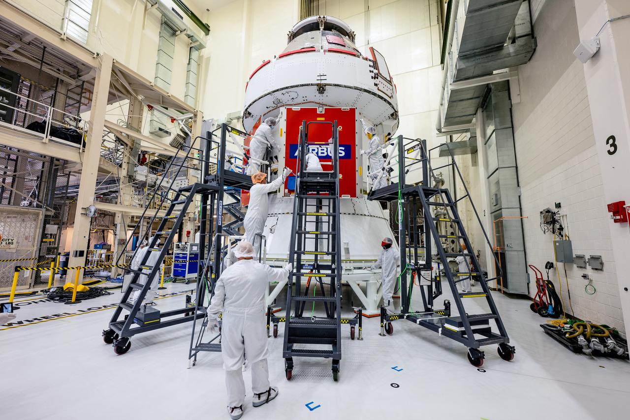 In the Operations and Checkout Building (O&amp;C) at Kennedy Space Center, three spacecraft adapter jettison (SAJ) fairings are prepared for installation and will be moved into place by technicians with Lockheed Martin, lead contractor for Orion on Oct. 12, 2020. They will be secured around the spacecraft, encapsulating the European Service Module to protect it from the harsh environment as the spacecraft is propelled out of Earth’s atmosphere atop the Space Launch System (SLS) rocket during NASA’s Artemis I mission. The next time the solar array wings will be visible will be when Orion is in space. Artemis I will test the Orion spacecraft and SLS as an integrated system ahead of crewed flights to the Moon.