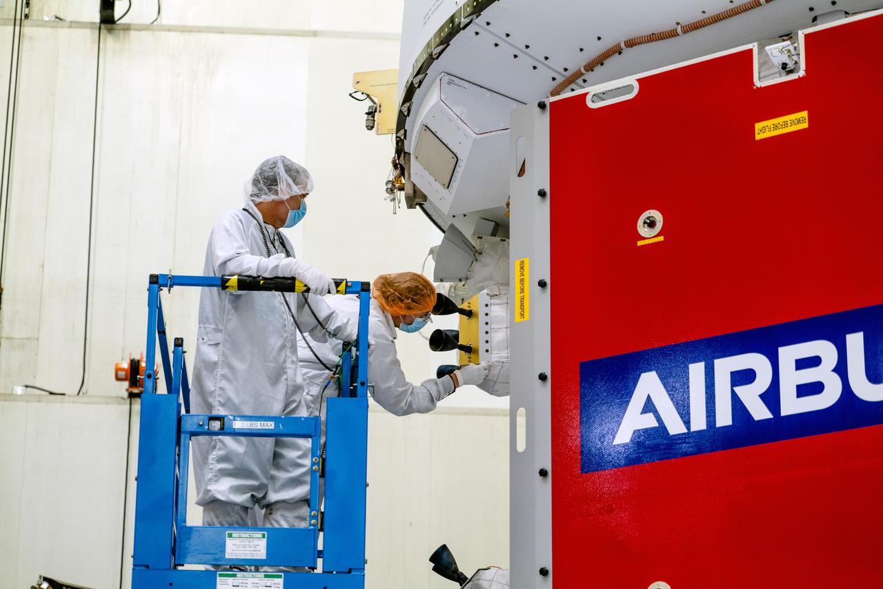 In the Operations and Checkout Building (O&amp;C) at Kennedy Space Center, three spacecraft adapter jettison (SAJ) fairings are prepared for installation and will be moved into place by technicians with Lockheed Martin, lead contractor for Orion on Oct. 12, 2020. They will be secured around the spacecraft, encapsulating the European Service Module to protect it from the harsh environment as the spacecraft is propelled out of Earth’s atmosphere atop the Space Launch System (SLS) rocket during NASA’s Artemis I mission. The next time the solar array wings will be visible will be when Orion is in space. Artemis I will test the Orion spacecraft and SLS as an integrated system ahead of crewed flights to the Moon.