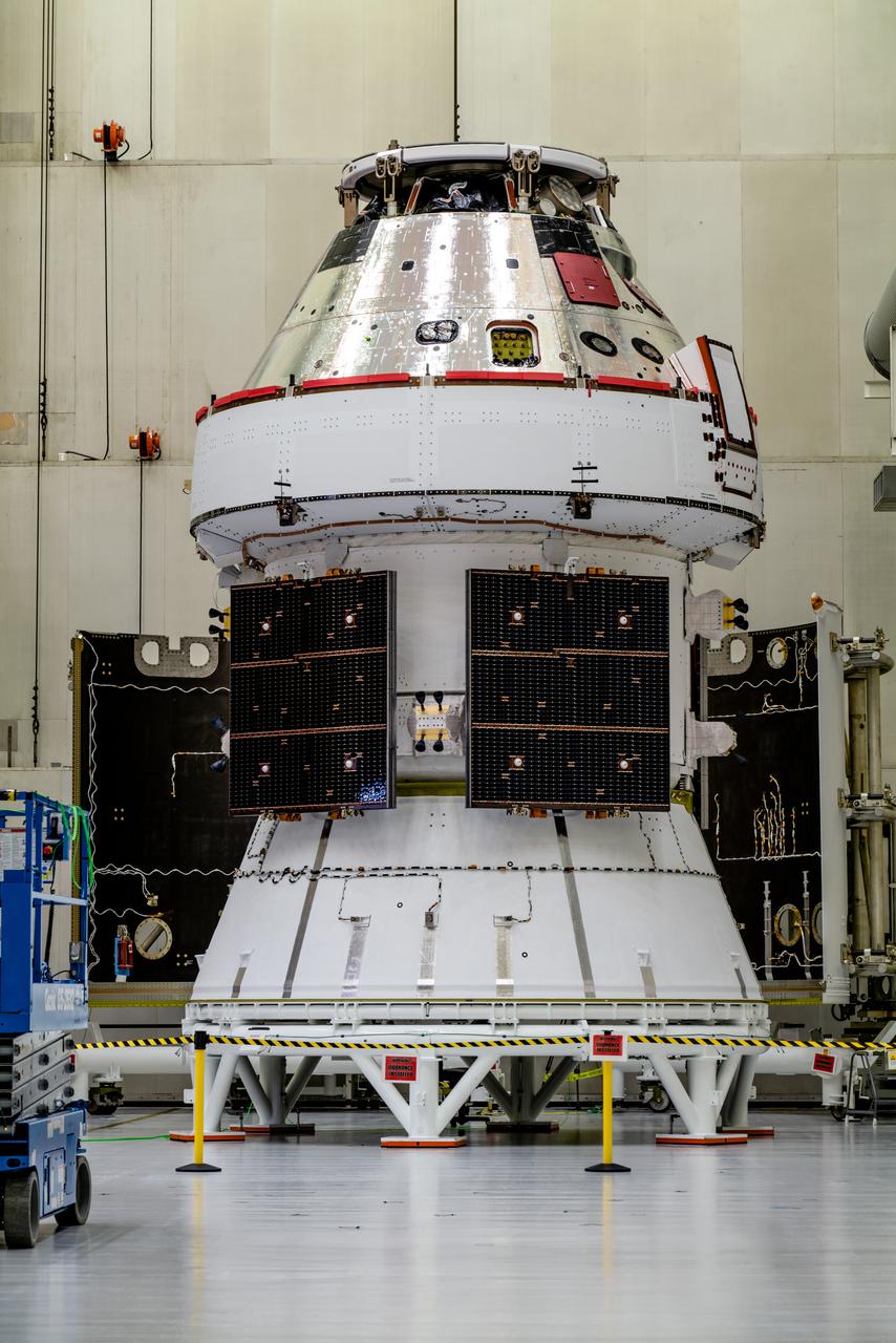 In the Operations and Checkout Building (O&amp;C) at Kennedy Space Center, three spacecraft adapter jettison (SAJ) fairings are prepared for installation and will be moved into place by technicians with Lockheed Martin, lead contractor for Orion on Oct. 12, 2020. They will be secured around the spacecraft, encapsulating the European Service Module to protect it from the harsh environment as the spacecraft is propelled out of Earth’s atmosphere atop the Space Launch System (SLS) rocket during NASA’s Artemis I mission. The next time the solar array wings will be visible will be when Orion is in space. Artemis I will test the Orion spacecraft and SLS as an integrated system ahead of crewed flights to the Moon.