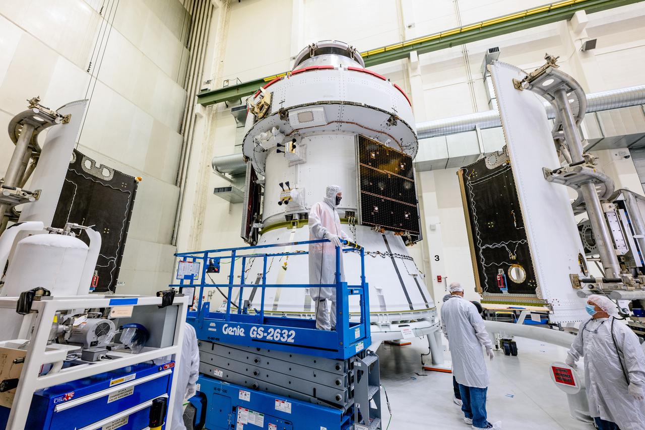 In the Operations and Checkout Building (O&amp;C) at Kennedy Space Center, three spacecraft adapter jettison (SAJ) fairings are prepared for installation and will be moved into place by technicians with Lockheed Martin, lead contractor for Orion on Oct. 12, 2020. They will be secured around the spacecraft, encapsulating the European Service Module to protect it from the harsh environment as the spacecraft is propelled out of Earth’s atmosphere atop the Space Launch System (SLS) rocket during NASA’s Artemis I mission. The next time the solar array wings will be visible will be when Orion is in space. Artemis I will test the Orion spacecraft and SLS as an integrated system ahead of crewed flights to the Moon.