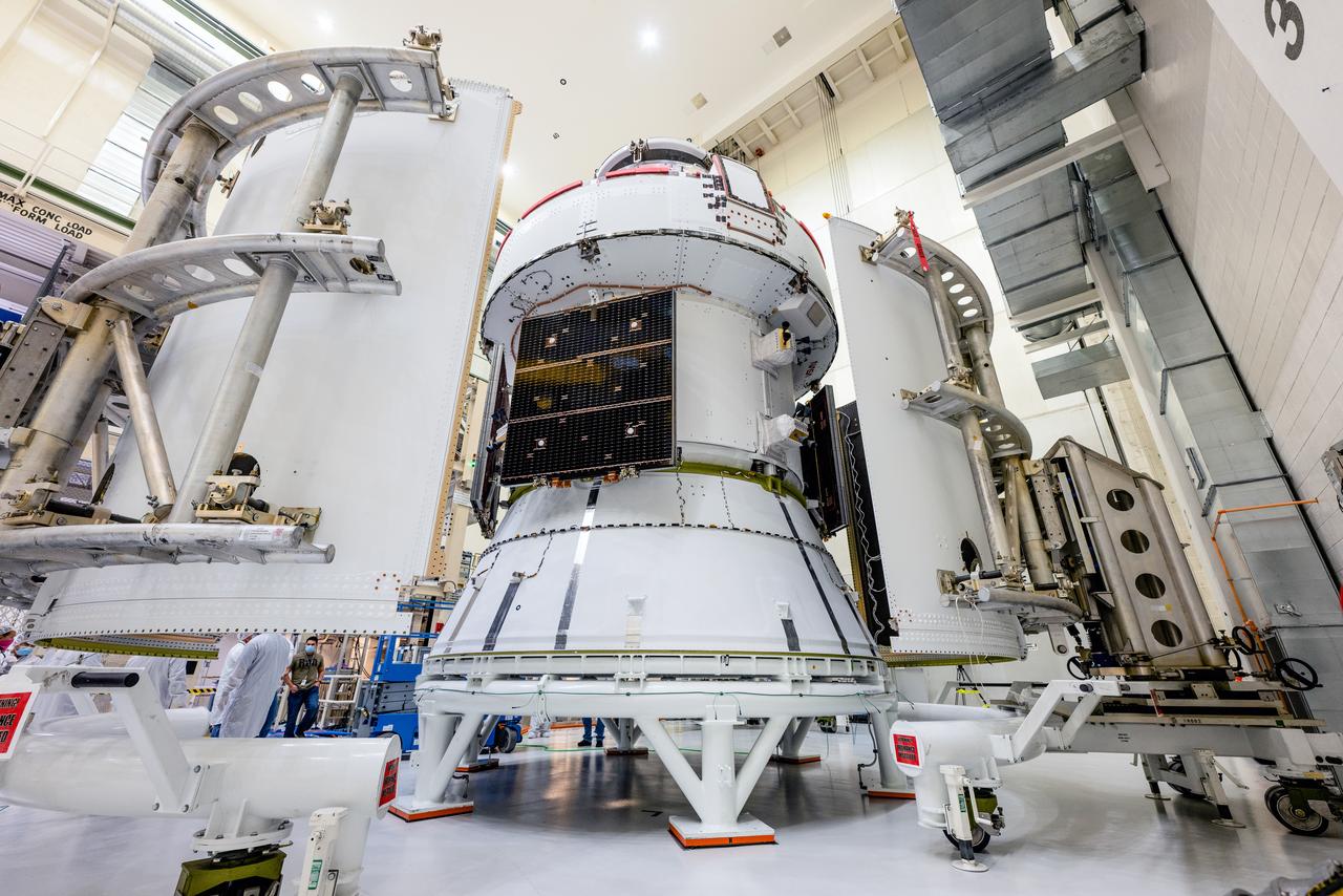 In the Operations and Checkout Building (O&amp;C) at Kennedy Space Center, three spacecraft adapter jettison (SAJ) fairings are prepared for installation and will be moved into place by technicians with Lockheed Martin, lead contractor for Orion on Oct. 12, 2020. They will be secured around the spacecraft, encapsulating the European Service Module to protect it from the harsh environment as the spacecraft is propelled out of Earth’s atmosphere atop the Space Launch System (SLS) rocket during NASA’s Artemis I mission. The next time the solar array wings will be visible will be when Orion is in space. Artemis I will test the Orion spacecraft and SLS as an integrated system ahead of crewed flights to the Moon.