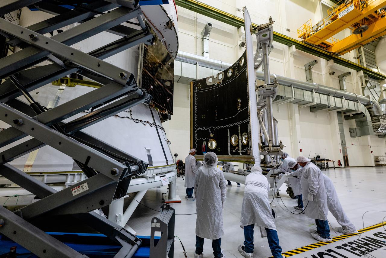 In the Operations and Checkout Building (O&amp;C) at Kennedy Space Center, three spacecraft adapter jettison (SAJ) fairings are prepared for installation and will be moved into place by technicians with Lockheed Martin, lead contractor for Orion on Oct. 12, 2020. They will be secured around the spacecraft, encapsulating the European Service Module to protect it from the harsh environment as the spacecraft is propelled out of Earth’s atmosphere atop the Space Launch System (SLS) rocket during NASA’s Artemis I mission. The next time the solar array wings will be visible will be when Orion is in space. Artemis I will test the Orion spacecraft and SLS as an integrated system ahead of crewed flights to the Moon.