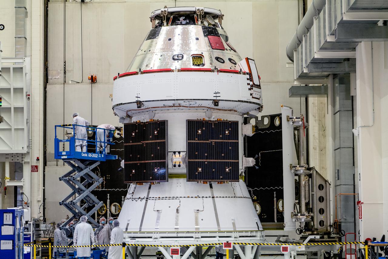 In the Operations and Checkout Building (O&amp;C) at Kennedy Space Center, three spacecraft adapter jettison (SAJ) fairings are prepared for installation and will be moved into place by technicians with Lockheed Martin, lead contractor for Orion on Oct. 12, 2020. They will be secured around the spacecraft, encapsulating the European Service Module to protect it from the harsh environment as the spacecraft is propelled out of Earth’s atmosphere atop the Space Launch System (SLS) rocket during NASA’s Artemis I mission. The next time the solar array wings will be visible will be when Orion is in space. Artemis I will test the Orion spacecraft and SLS as an integrated system ahead of crewed flights to the Moon.