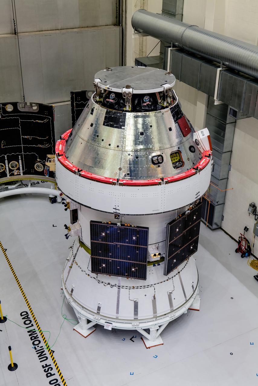 In the Operations and Checkout Building (O&amp;C) at Kennedy Space Center, three spacecraft adapter jettison (SAJ) fairings are prepared for installation and will be moved into place by technicians with Lockheed Martin, lead contractor for Orion on Oct. 12, 2020. They will be secured around the spacecraft, encapsulating the European Service Module to protect it from the harsh environment as the spacecraft is propelled out of Earth’s atmosphere atop the Space Launch System (SLS) rocket during NASA’s Artemis I mission. The next time the solar array wings will be visible will be when Orion is in space. Artemis I will test the Orion spacecraft and SLS as an integrated system ahead of crewed flights to the Moon.