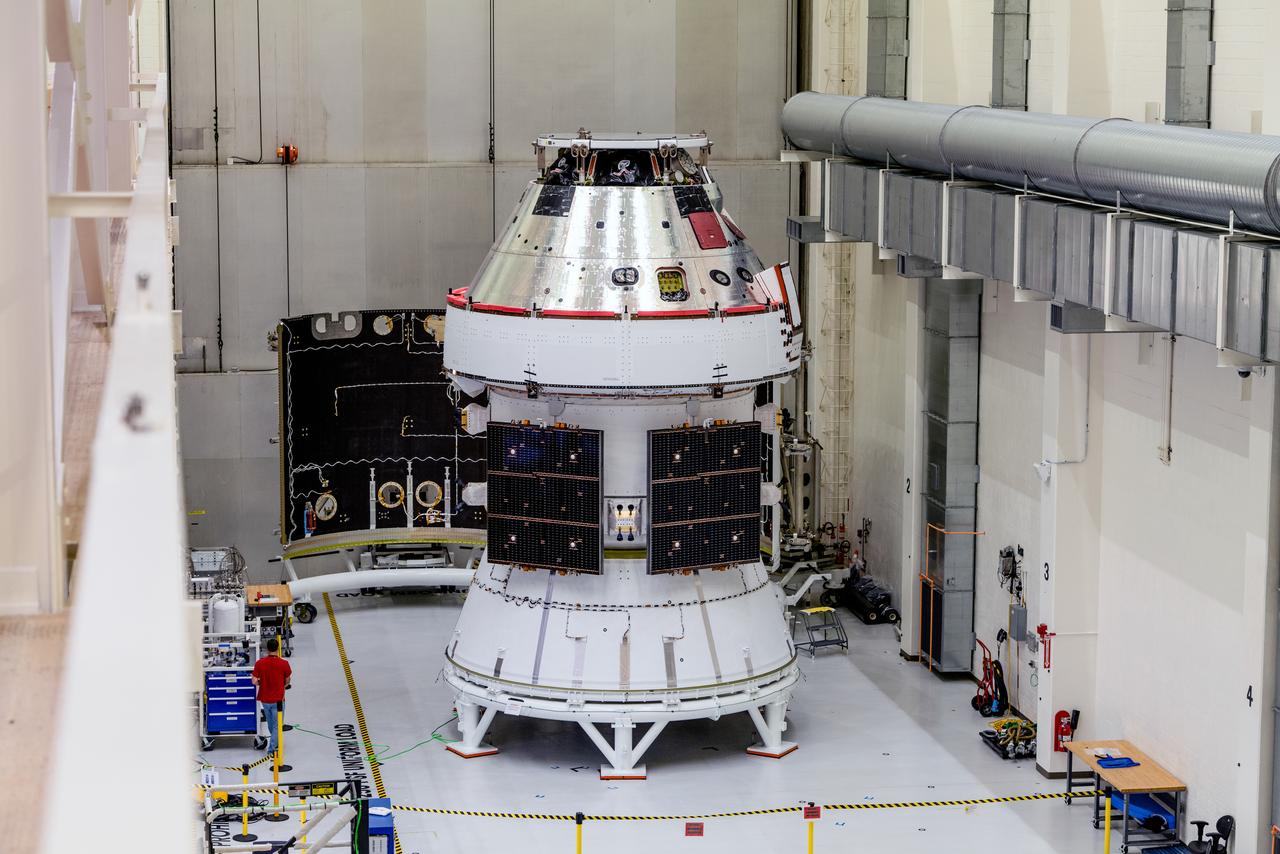 In the Operations and Checkout Building (O&amp;C) at Kennedy Space Center, three spacecraft adapter jettison (SAJ) fairings are prepared for installation and will be moved into place by technicians with Lockheed Martin, lead contractor for Orion on Oct. 12, 2020. They will be secured around the spacecraft, encapsulating the European Service Module to protect it from the harsh environment as the spacecraft is propelled out of Earth’s atmosphere atop the Space Launch System (SLS) rocket during NASA’s Artemis I mission. The next time the solar array wings will be visible will be when Orion is in space. Artemis I will test the Orion spacecraft and SLS as an integrated system ahead of crewed flights to the Moon.