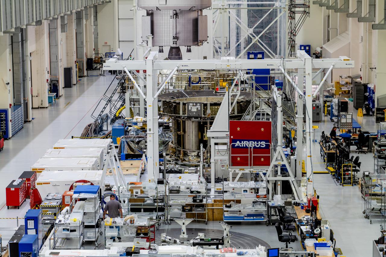 In the Operations and Checkout Building (O&amp;C) at Kennedy Space Center, three spacecraft adapter jettison (SAJ) fairings are prepared for installation and will be moved into place by technicians with Lockheed Martin, lead contractor for Orion on Oct. 12, 2020. They will be secured around the spacecraft, encapsulating the European Service Module to protect it from the harsh environment as the spacecraft is propelled out of Earth’s atmosphere atop the Space Launch System (SLS) rocket during NASA’s Artemis I mission. The next time the solar array wings will be visible will be when Orion is in space. Artemis I will test the Orion spacecraft and SLS as an integrated system ahead of crewed flights to the Moon.
