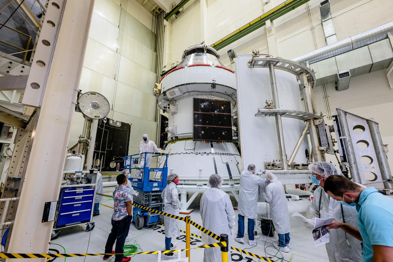 In the Operations and Checkout Building (O&amp;C) at Kennedy Space Center, three spacecraft adapter jettison (SAJ) fairings are prepared for installation and will be moved into place by technicians with Lockheed Martin, lead contractor for Orion on Oct. 12, 2020. They will be secured around the spacecraft, encapsulating the European Service Module to protect it from the harsh environment as the spacecraft is propelled out of Earth’s atmosphere atop the Space Launch System (SLS) rocket during NASA’s Artemis I mission. The next time the solar array wings will be visible will be when Orion is in space. Artemis I will test the Orion spacecraft and SLS as an integrated system ahead of crewed flights to the Moon.