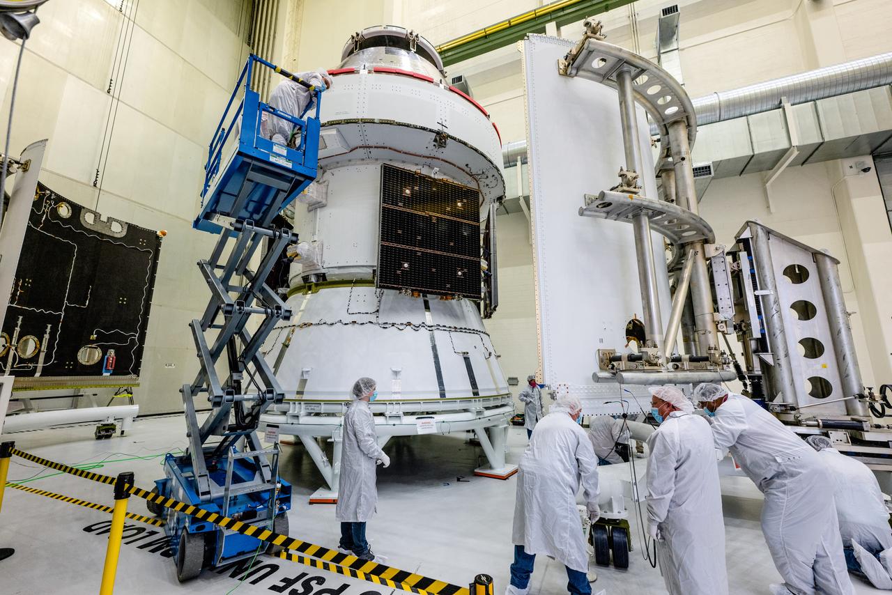 In the Operations and Checkout Building (O&amp;C) at Kennedy Space Center, three spacecraft adapter jettison (SAJ) fairings are prepared for installation and will be moved into place by technicians with Lockheed Martin, lead contractor for Orion on Oct. 12, 2020. They will be secured around the spacecraft, encapsulating the European Service Module to protect it from the harsh environment as the spacecraft is propelled out of Earth’s atmosphere atop the Space Launch System (SLS) rocket during NASA’s Artemis I mission. The next time the solar array wings will be visible will be when Orion is in space. Artemis I will test the Orion spacecraft and SLS as an integrated system ahead of crewed flights to the Moon.