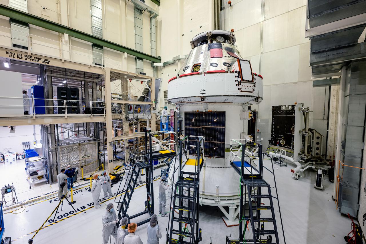 In the Operations and Checkout Building (O&amp;C) at Kennedy Space Center, three spacecraft adapter jettison (SAJ) fairings are prepared for installation and will be moved into place by technicians with Lockheed Martin, lead contractor for Orion on Oct. 12, 2020. They will be secured around the spacecraft, encapsulating the European Service Module to protect it from the harsh environment as the spacecraft is propelled out of Earth’s atmosphere atop the Space Launch System (SLS) rocket during NASA’s Artemis I mission. The next time the solar array wings will be visible will be when Orion is in space. Artemis I will test the Orion spacecraft and SLS as an integrated system ahead of crewed flights to the Moon.