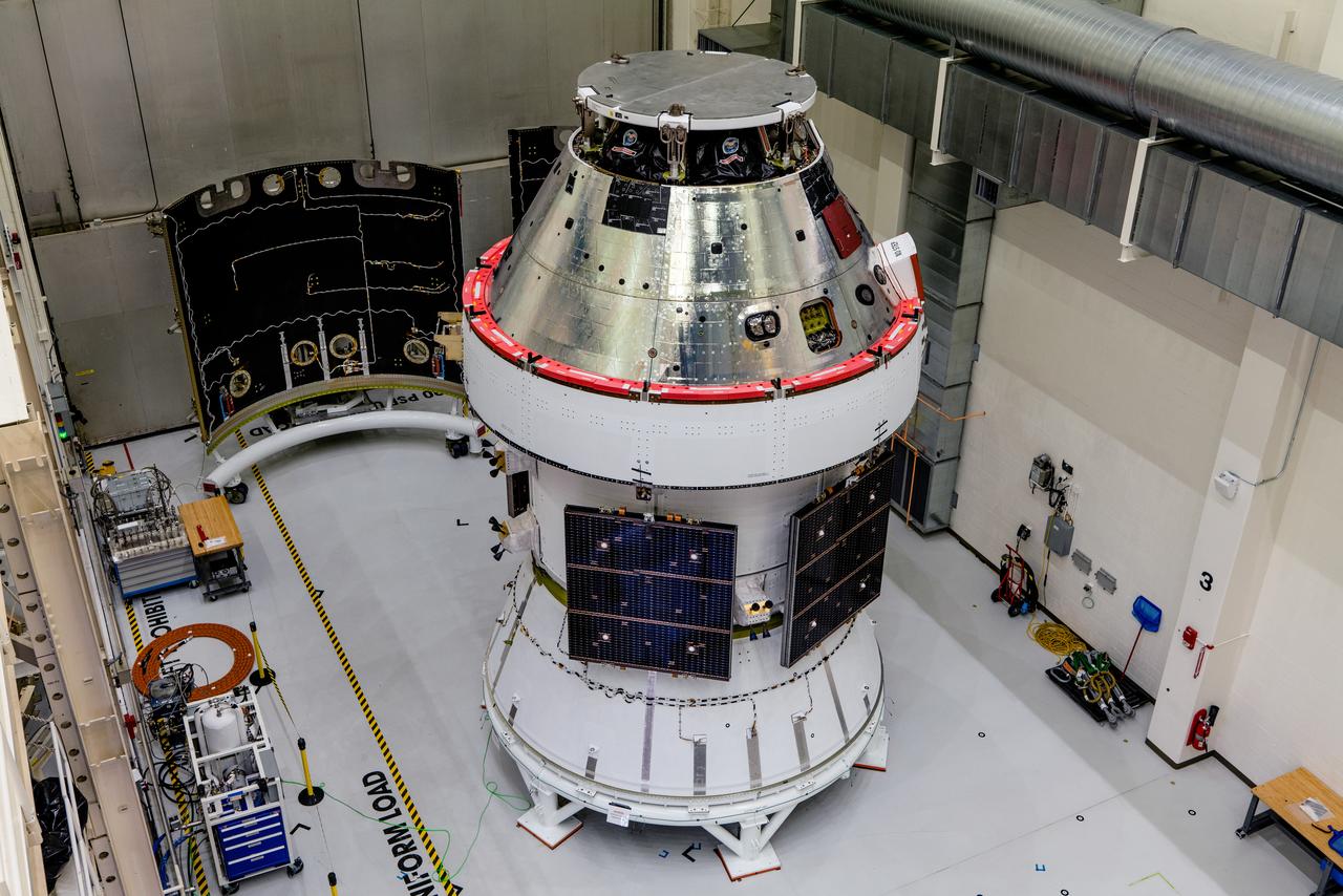 In the Operations and Checkout Building (O&amp;C) at Kennedy Space Center, three spacecraft adapter jettison (SAJ) fairings are prepared for installation and will be moved into place by technicians with Lockheed Martin, lead contractor for Orion on Oct. 12, 2020. They will be secured around the spacecraft, encapsulating the European Service Module to protect it from the harsh environment as the spacecraft is propelled out of Earth’s atmosphere atop the Space Launch System (SLS) rocket during NASA’s Artemis I mission. The next time the solar array wings will be visible will be when Orion is in space. Artemis I will test the Orion spacecraft and SLS as an integrated system ahead of crewed flights to the Moon.