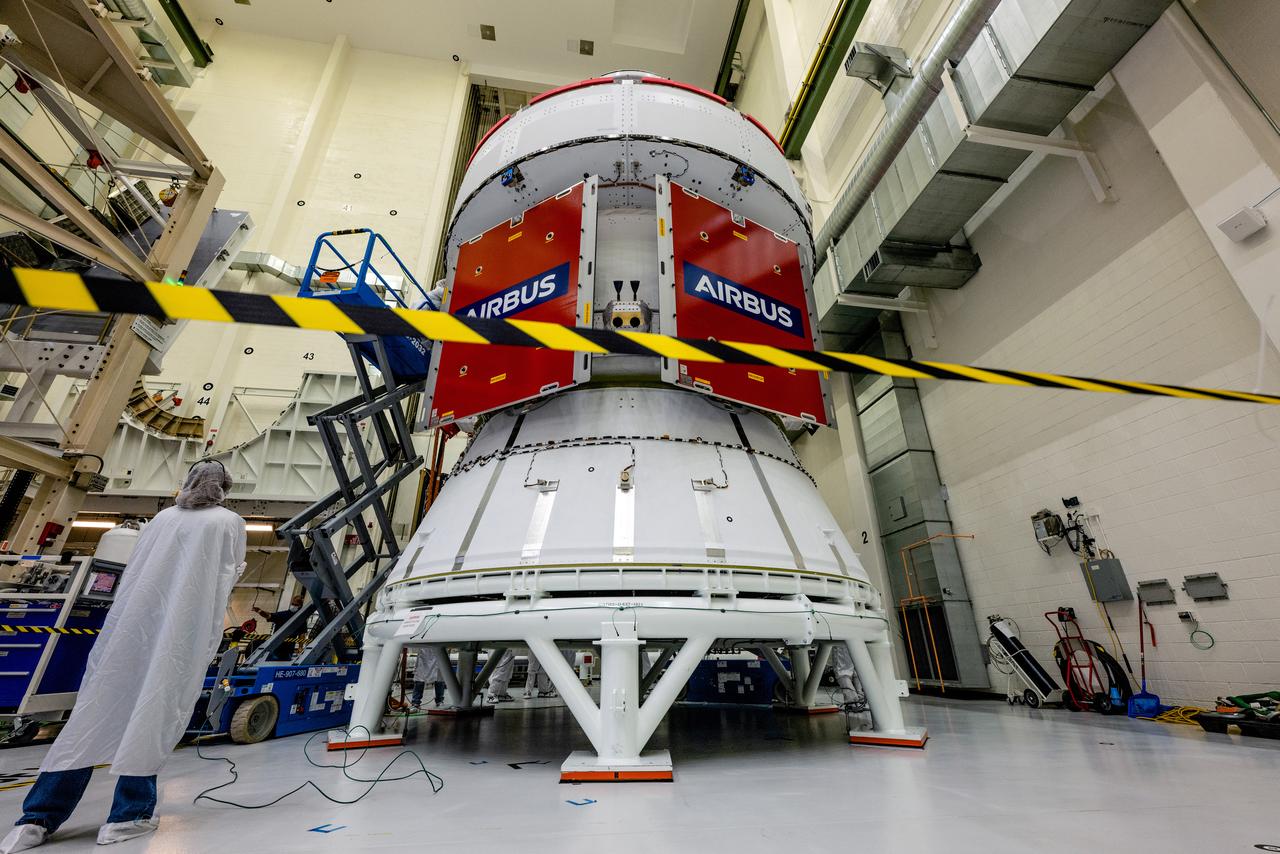 In the Operations and Checkout Building (O&amp;C) at Kennedy Space Center, three spacecraft adapter jettison (SAJ) fairings are prepared for installation and will be moved into place by technicians with Lockheed Martin, lead contractor for Orion on Oct. 12, 2020. They will be secured around the spacecraft, encapsulating the European Service Module to protect it from the harsh environment as the spacecraft is propelled out of Earth’s atmosphere atop the Space Launch System (SLS) rocket during NASA’s Artemis I mission. The next time the solar array wings will be visible will be when Orion is in space. Artemis I will test the Orion spacecraft and SLS as an integrated system ahead of crewed flights to the Moon.