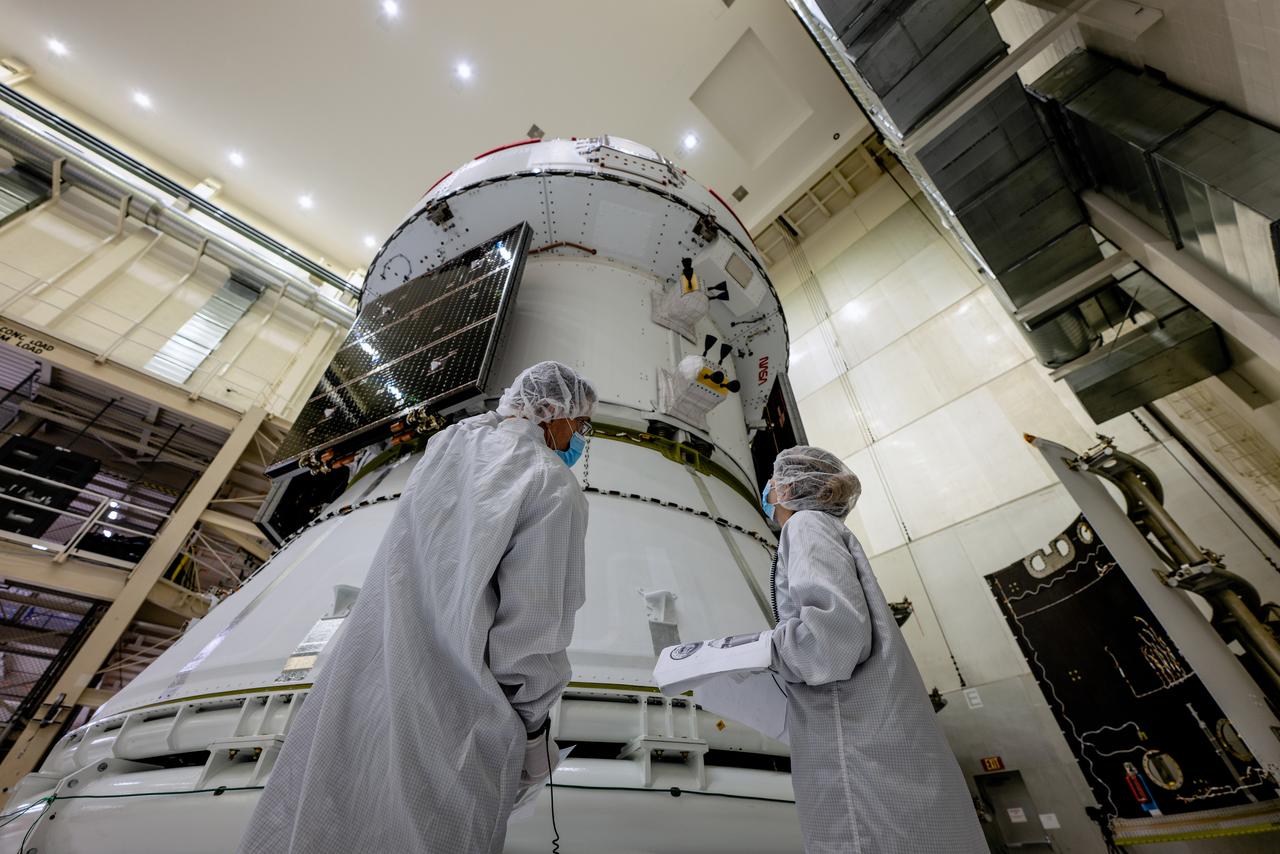 In the Operations and Checkout Building (O&amp;C) at Kennedy Space Center, three spacecraft adapter jettison (SAJ) fairings are prepared for installation and will be moved into place by technicians with Lockheed Martin, lead contractor for Orion on Oct. 12, 2020. They will be secured around the spacecraft, encapsulating the European Service Module to protect it from the harsh environment as the spacecraft is propelled out of Earth’s atmosphere atop the Space Launch System (SLS) rocket during NASA’s Artemis I mission. The next time the solar array wings will be visible will be when Orion is in space. Artemis I will test the Orion spacecraft and SLS as an integrated system ahead of crewed flights to the Moon.