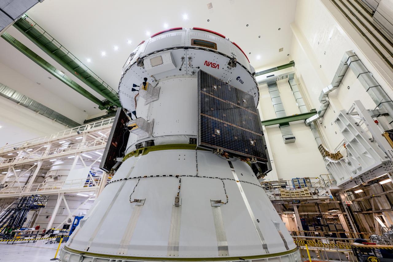 In the Operations and Checkout Building (O&amp;C) at Kennedy Space Center, three spacecraft adapter jettison (SAJ) fairings are prepared for installation and will be moved into place by technicians with Lockheed Martin, lead contractor for Orion on Oct. 12, 2020. They will be secured around the spacecraft, encapsulating the European Service Module to protect it from the harsh environment as the spacecraft is propelled out of Earth’s atmosphere atop the Space Launch System (SLS) rocket during NASA’s Artemis I mission. The next time the solar array wings will be visible will be when Orion is in space. Artemis I will test the Orion spacecraft and SLS as an integrated system ahead of crewed flights to the Moon.
