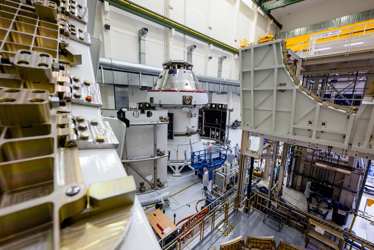 In the Operations and Checkout Building (O&amp;C) at Kennedy Space Center, three spacecraft adapter jettison (SAJ) fairings are prepared for installation and will be moved into place by technicians with Lockheed Martin, lead contractor for Orion on Oct. 12, 2020. They will be secured around the spacecraft, encapsulating the European Service Module to protect it from the harsh environment as the spacecraft is propelled out of Earth’s atmosphere atop the Space Launch System (SLS) rocket during NASA’s Artemis I mission. The next time the solar array wings will be visible will be when Orion is in space. Artemis I will test the Orion spacecraft and SLS as an integrated system ahead of crewed flights to the Moon.