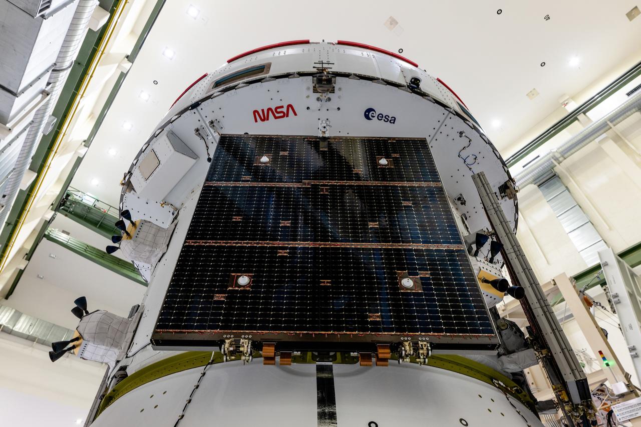 In the Operations and Checkout Building (O&amp;C) at Kennedy Space Center, three spacecraft adapter jettison (SAJ) fairings are prepared for installation and will be moved into place by technicians with Lockheed Martin, lead contractor for Orion on Oct. 12, 2020. They will be secured around the spacecraft, encapsulating the European Service Module to protect it from the harsh environment as the spacecraft is propelled out of Earth’s atmosphere atop the Space Launch System (SLS) rocket during NASA’s Artemis I mission. The next time the solar array wings will be visible will be when Orion is in space. Artemis I will test the Orion spacecraft and SLS as an integrated system ahead of crewed flights to the Moon.