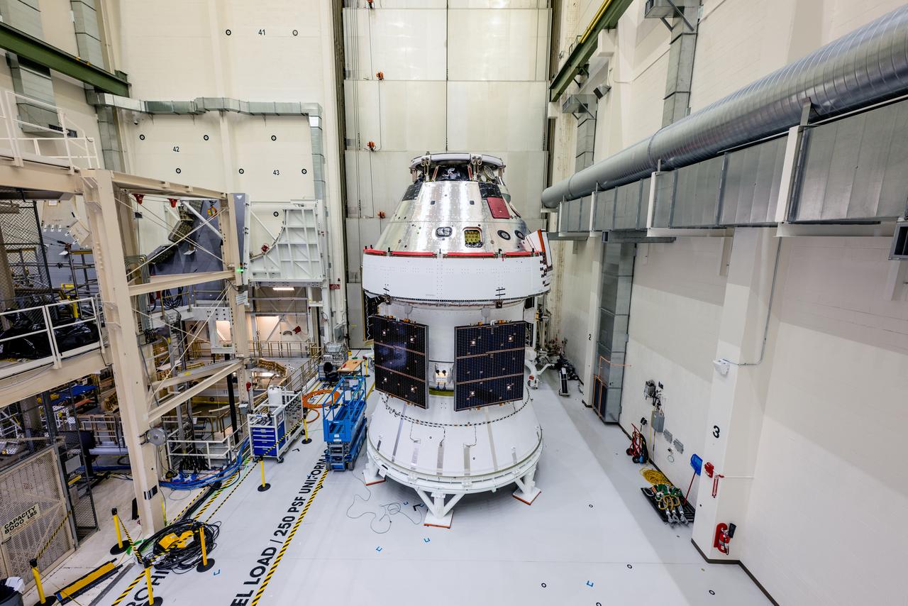 In the Operations and Checkout Building (O&amp;C) at Kennedy Space Center, three spacecraft adapter jettison (SAJ) fairings are prepared for installation and will be moved into place by technicians with Lockheed Martin, lead contractor for Orion on Oct. 12, 2020. They will be secured around the spacecraft, encapsulating the European Service Module to protect it from the harsh environment as the spacecraft is propelled out of Earth’s atmosphere atop the Space Launch System (SLS) rocket during NASA’s Artemis I mission. The next time the solar array wings will be visible will be when Orion is in space. Artemis I will test the Orion spacecraft and SLS as an integrated system ahead of crewed flights to the Moon.