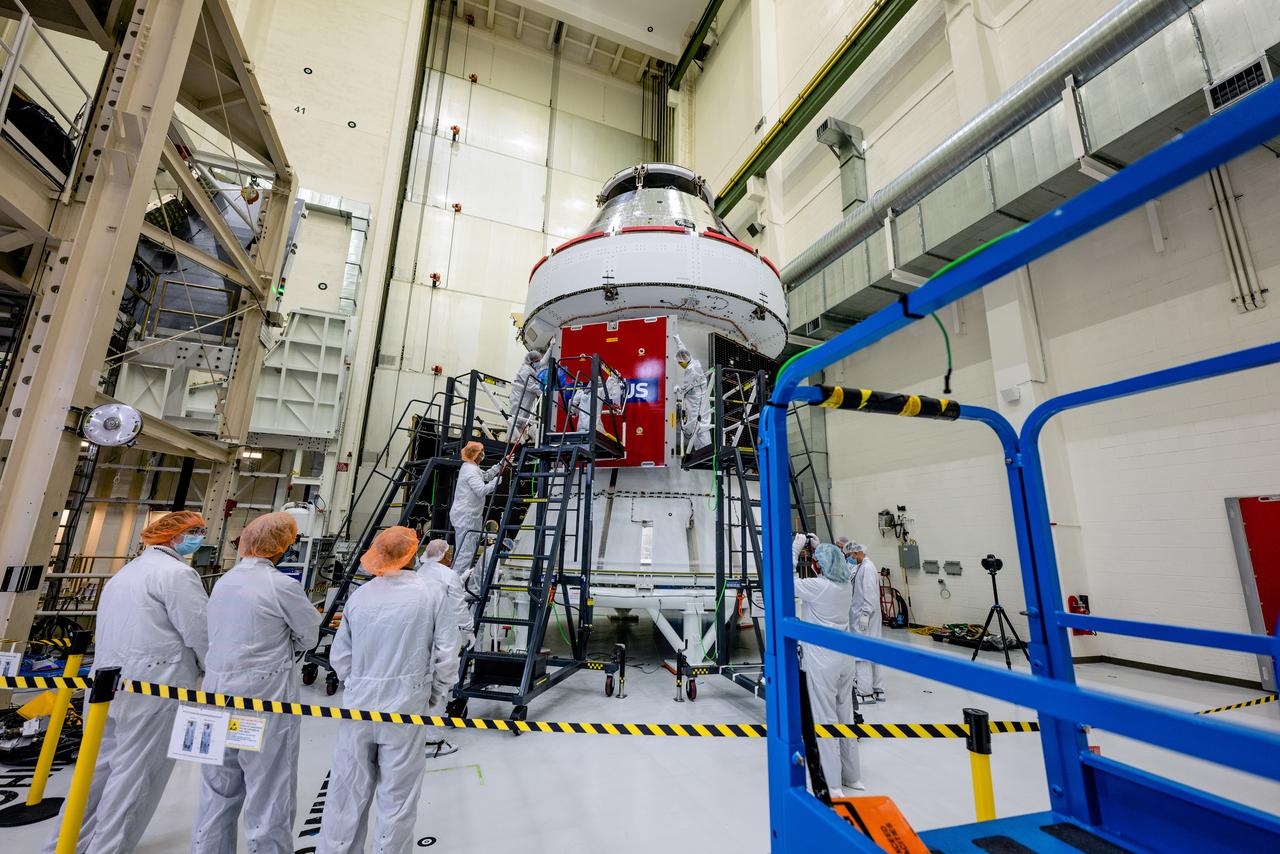 In the Operations and Checkout Building (O&C) at Kennedy Space Center, three spacecraft adapter jettison (SAJ) fairings are prepared for installation and will be moved into place by technicians with Lockheed Martin, lead contractor for Orion on Oct. 12, 2020. They will be secured around the spacecraft, encapsulating the European Service Module to protect it from the harsh environment as the spacecraft is propelled out of Earth’s atmosphere atop the Space Launch System (SLS) rocket during NASA’s Artemis I mission. The next time the solar array wings will be visible will be when Orion is in space. Artemis I will test the Orion spacecraft and SLS as an integrated system ahead of crewed flights to the Moon.