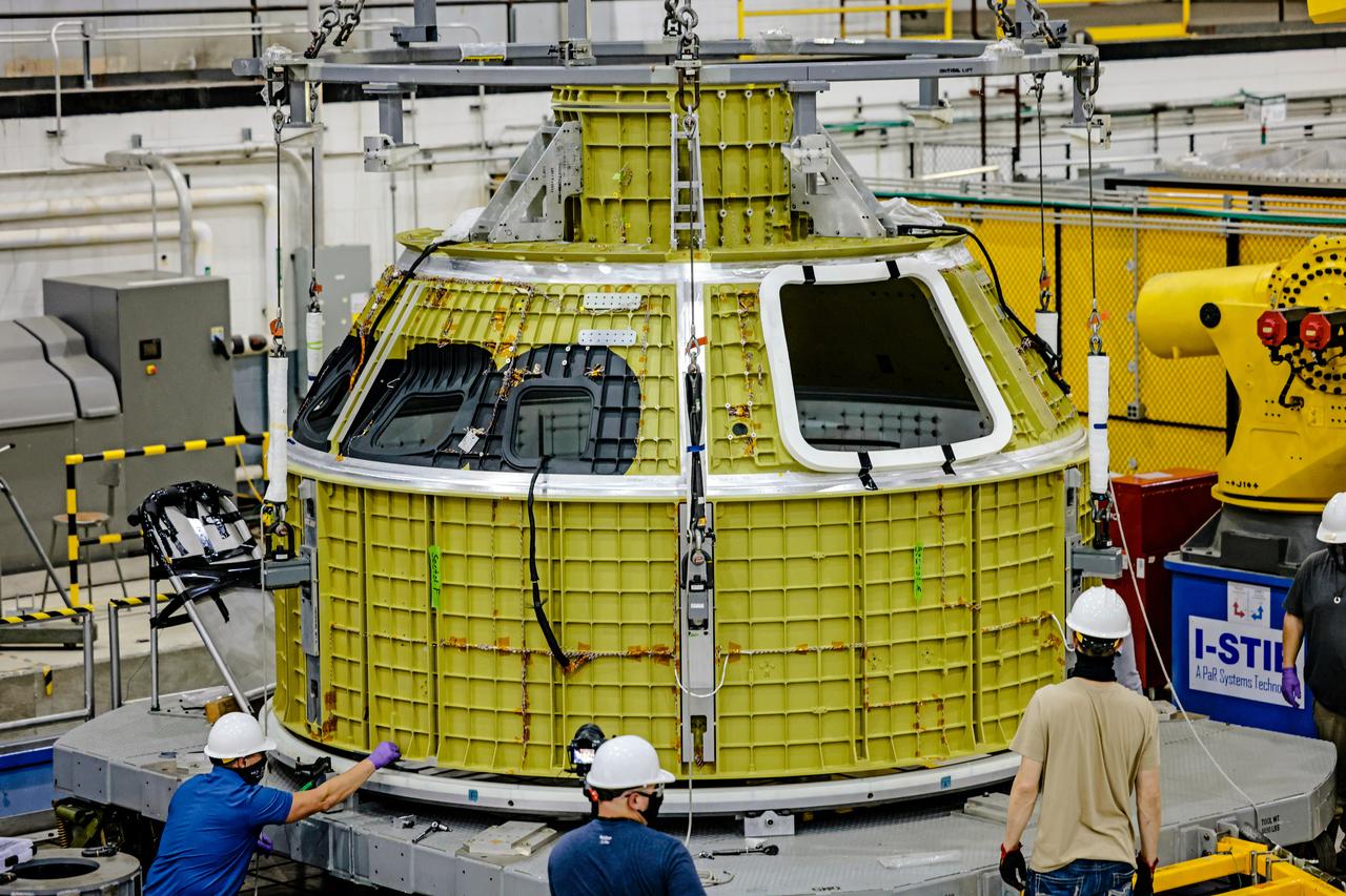 At NASA's Michoud Assembly Facility in New Orleans, Orion's newly completed pressure vessel for the Artemis III mission is lifted out of the welding tool on Aug. 27, 2021. The pressure vessel is the primary structure for Orion's crew module, joined together using state-of-the-art welding by technicians from lead contractor Lockheed Martin.