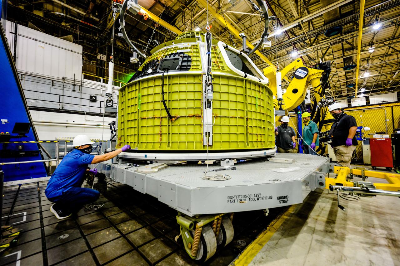 At NASA's Michoud Assembly Facility in New Orleans, Orion's newly completed pressure vessel for the Artemis III mission is lifted out of the welding tool on Aug. 27, 2021. The pressure vessel is the primary structure for Orion's crew module, joined together using state-of-the-art welding by technicians from lead contractor Lockheed Martin.