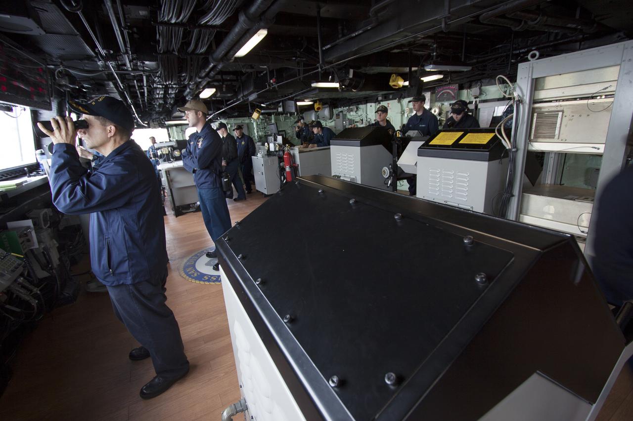 At the U.S. Naval Base San Diego in California, the USS San Diego heads out to sea with the Orion boilerplate test vehicle and other hardware in its well deck for an underway recovery test on March 6, 2014. U.S. Navy personnel monitor conditions as the ship leaves port. About 100 miles offshore, NASA and the U.S. Navy conducted tests to prepare for recovery of the Orion crew module, forward bay cover and parachutes on its return from a deep space mission. The underway recovery test will allow the teams to demonstrate and evaluate the recovery processes, procedures, hardware and personnel in open waters. During the testing, the tether lines were unable to support the tension caused by crew module motion that was driven by wave turbulence in the well deck of the ship. NASA and the U.S. Navy are reviewing the testing data collected to evaluate the next steps. The Ground Systems Development and Operations Program conducted the underway recovery tests. Orion is the exploration spacecraft designed to carry astronauts to destinations not yet explored by humans, including an asteroid and Mars. It will have emergency abort capability, sustain the crew during space travel and provide safe re-entry from deep space return velocities.