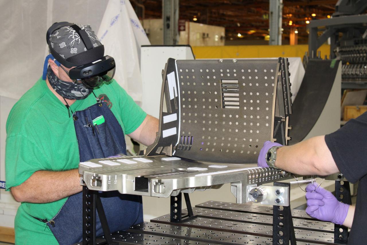 Lockheed Martin technicians at Michoud Assembly Facility in New Orleans complete the final assembly of the crew seat for the Artemis I flight on Sept. 23, 2020. The seat will hold a mass simulator and measure launch and landing loads during the flight which will see Orion travel 40,000 miles past the Moon. The seat will also be reused on Artemis II, Orion's first crewed flight.