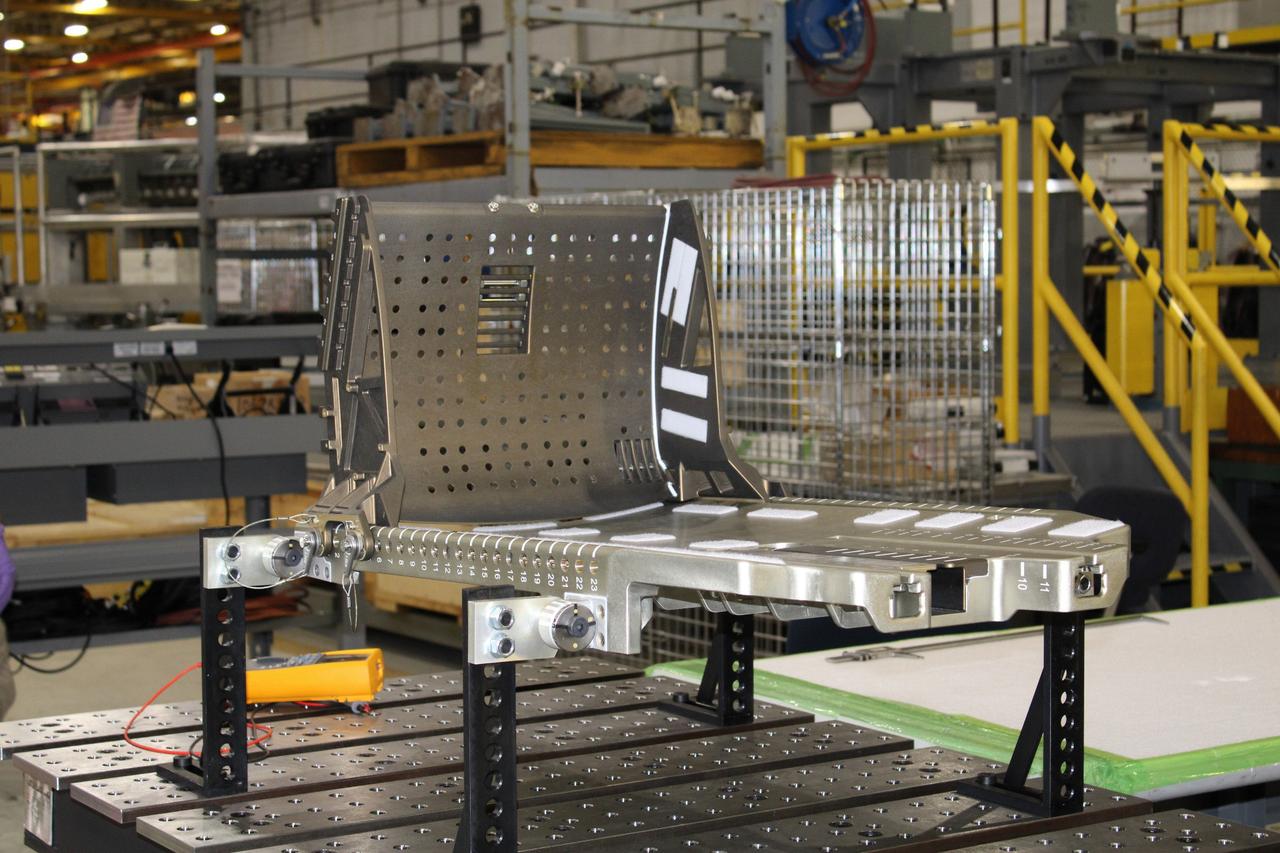 Lockheed Martin technicians at Michoud Assembly Facility in New Orleans complete the final assembly of the crew seat for the Artemis I flight on Sept. 23, 2020. The seat will hold a mass simulator and measure launch and landing loads during the flight which will see Orion travel 40,000 miles past the Moon. The seat will also be reused on Artemis II, Orion's first crewed flight.