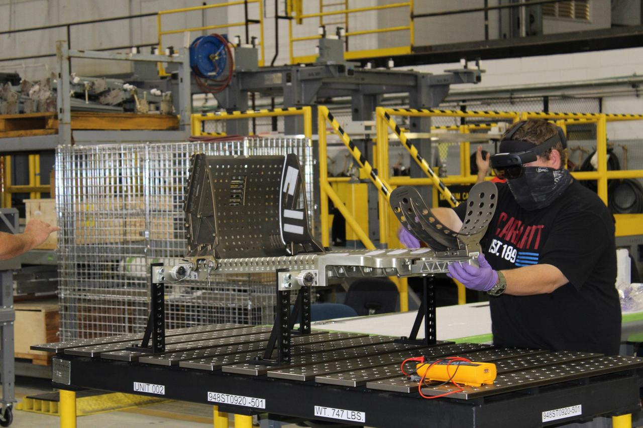 Lockheed Martin technicians at Michoud Assembly Facility in New Orleans complete the final assembly of the crew seat for the Artemis I flight on Sept. 23, 2020. The seat will hold a mass simulator and measure launch and landing loads during the flight which will see Orion travel 40,000 miles past the Moon. The seat will also be reused on Artemis II, Orion's first crewed flight.