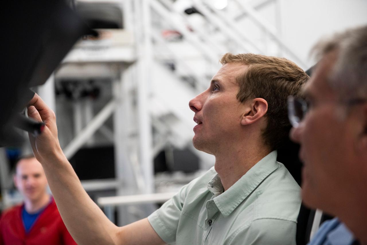 jsc2022e065069 (March 24, 2022) --- (From front to back) SpaceX Crew-6 Commander Stephen Bowen and Pilot Warren "Woody" Hoburg, both from NASA, are pictured during a cockpit training session at the company's headquarters in Hawthorne, California. Credit: SpaceX