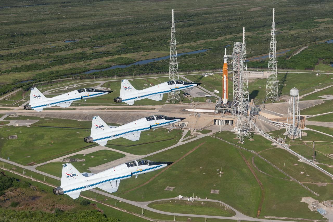 NASA's T-38 jets fly in formation above the Space Launch System rocket on Launch Pad 39B at NASA's Kennedy Space Center.     Aircraft designations and passengers:  NASA 901: Chris Condon / Astronaut Zena Cardman.  902: Astronaut Candidate Nicole Ayers / Astronaut Christina Koch.  903: Canadian Space Agency Astronaut Jeremy Hansen / Astronaut Drew Morgan.  904: Chief Astronaut Reid Wiseman / Astronaut Joe Acaba.  905 (Photo Chase): Astronaut Candidate Jack Hathaway / Josh Valcarcel  Credit: NASA/Josh Valcarcel