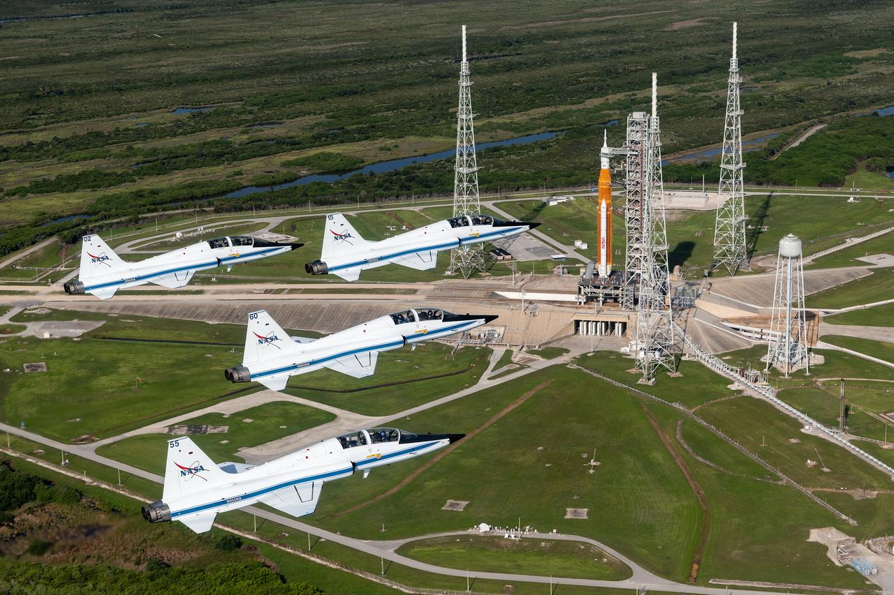 NASA astronauts piloting T-38 jets soar in formation above the Artemis I rocket on Launch Pad 39B as it awaits launch at NASA's Kennedy Space Center. Photographer: Josh Valcarcel – Johnson Space Center 