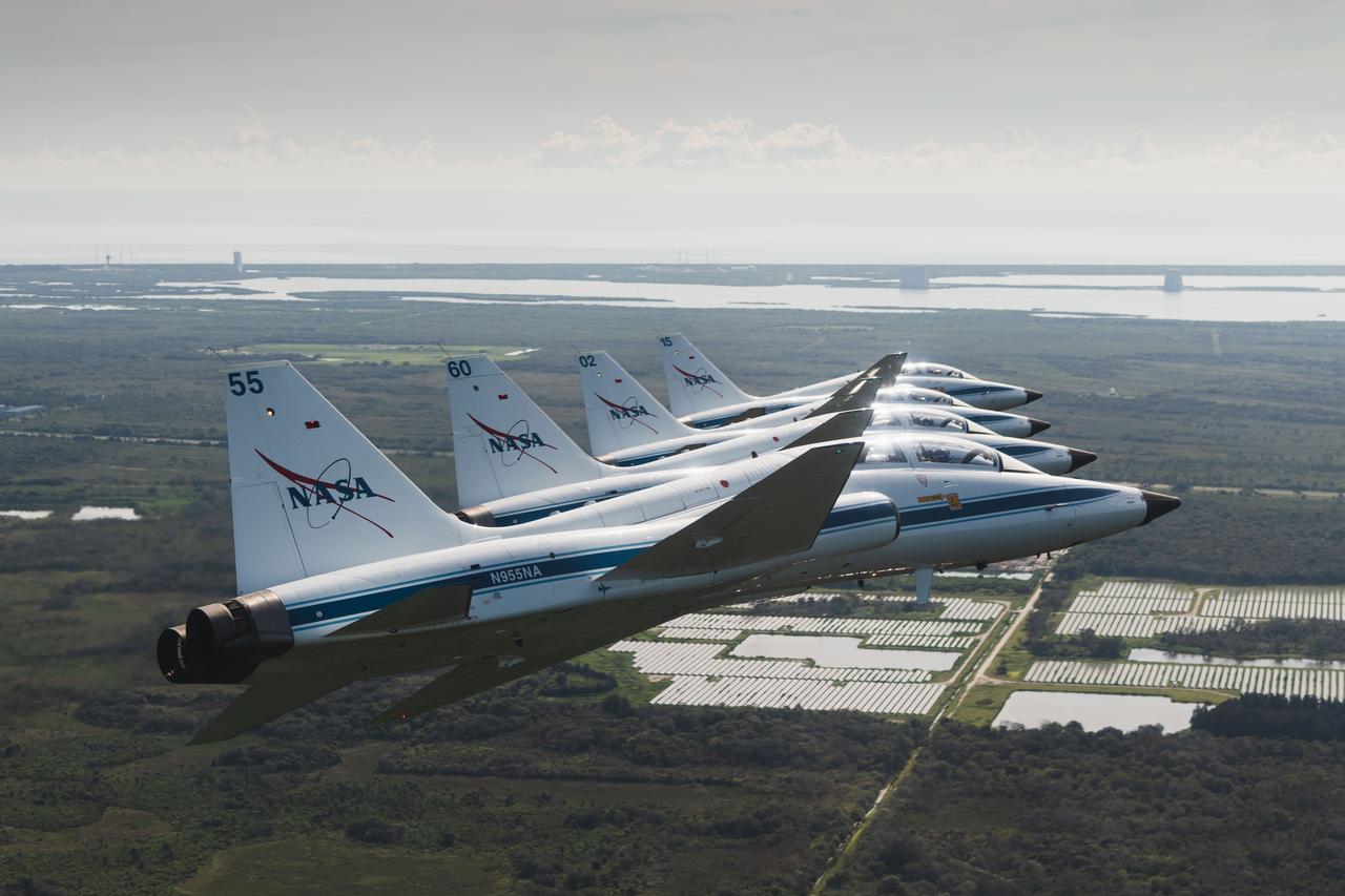 NASA T-38s fly in formation above NASA's Kennedy Space Center in Florida. Several astronauts and astronaut candidates traveled to view the Space Launch System rocket and Orion spacecraft on Launch Pad 39B, as well as support various pre-launch activities.   Aircraft designations and passengers:  NASA 901: Chris Condon / Astronaut Zena Cardman.  902: Astronaut Candidate Nicole Ayers / Astronaut Christina Koch.  903: Canadian Space Agency Astronaut Jeremy Hansen / Astronaut Drew Morgan.  904: Chief Astronaut Reid Wiseman / Astronaut Joe Acaba.  905 (Photo Chase): Astronaut Candidate Jack Hathaway / Josh Valcarcel.  Credit: NASA/Josh Valcarcel  PHOTOGRAPHER: Josh Valcarcel