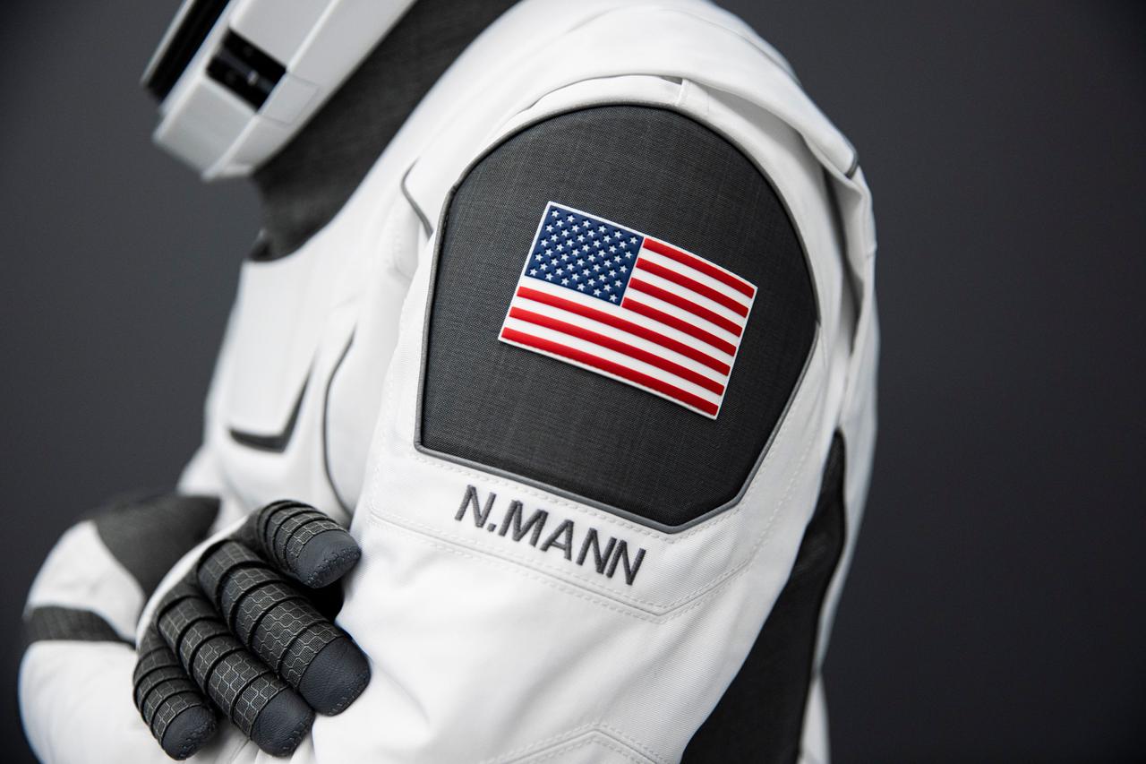 jsc2022e068611 (June 13, 2022) --- A patch representing the country of the United States, with the name of SpaceX Crew-5 Commander Nicole Aunapu Mann from NASA beneath, is pictured attached to her Crew Dragon flight suit. Credit: SpaceX