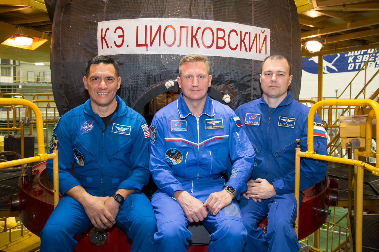 jsc2022e072268 (Sept. 7, 2022) --- At the Baikonur Cosmodrome in Kazakhstan, NASA astronaut Frank Rubio (left), Roscosmos cosmonaut Sergey Prokopyev (center) and Roscosmos cosmonaut Dmitri Petelin (right) complete training preparations in front of their Soyuz MS-22 spacecraft as they prepare for launch Sept. 21 for a six-month mission on the International Space Station. The Soyuz spacecraft bears the name of Konstantin Tsiolkovsky, the “father” of cosmonautics. Credit: NASA/Victor Zelentsov.