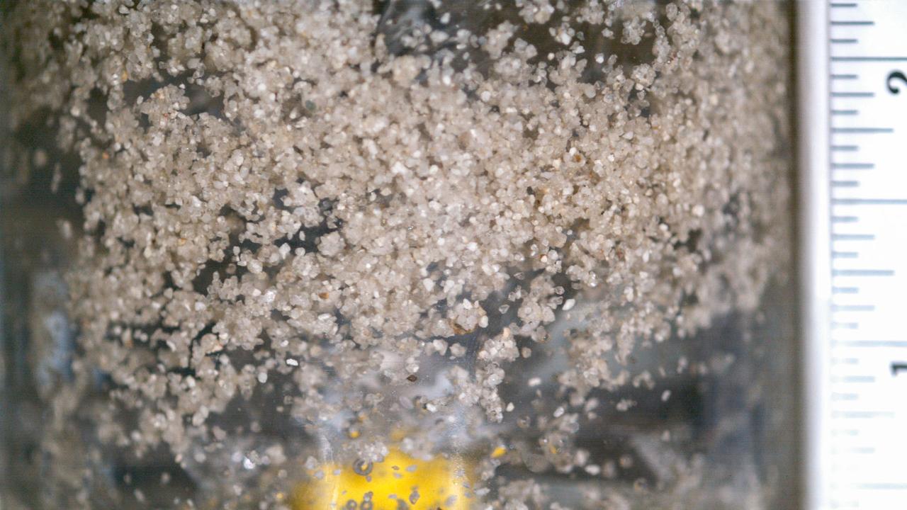 jsc2022e072959 (9/16/2022) --- Coarse hydrophobic sand is mixed for 25 seconds with water and air. Researchers observe a decent amount of agglomerates (air bubbles) covered by hydrophobic sand particles flowing in the water body. There are also free sand particles floating around. Catastrophic Post-Wildfire Mudflows studies the formation and stability of this bubble-sand structure in microgravity. A better understanding of these phenomena could improve the understanding, modeling, and predicting of mudflows and support development of innovative solutions to prevent catastrophic post-fire events. Image courtesy of the UCSD Geo-Micromechanics Research Group.