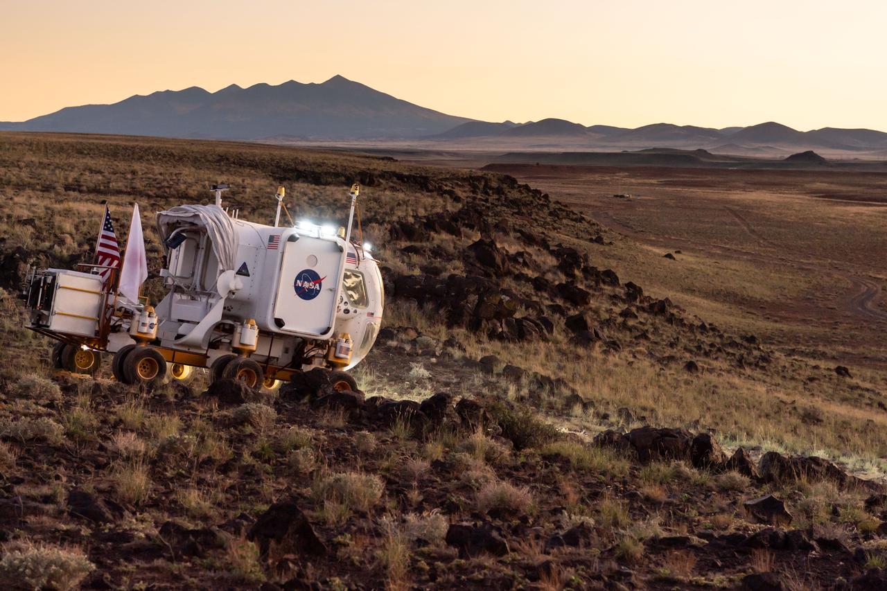 The Desert Research and Technology Studies (DesertRATS) is one of NASA’s analog missions to test hardware and operational scenarios in a remote environment with geographic similarities to the Moon and Mars. In October 2022, NASA evaluated rover design and operations, communications with the Mission Control Center and a Science Evaluation Room at NASA’s Johnson Space Center in Houston. A key element of the DesertRATS analog is the pressurized rover, a capability that is planned for astronaut surface exploration at the Moon and Mars. NASA has a study agreement with the Japan Aerospace Exploration Agency (JAXA) for development of the Artemis pressurized rover, and JAXA representatives  joined NASA at DesertRATS.