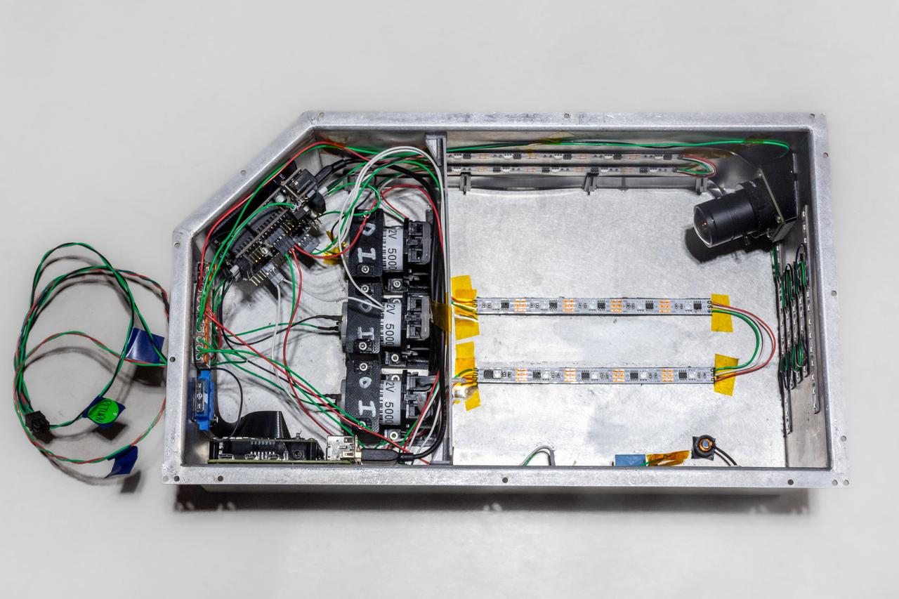 jsc2022e083567 (10/20/2022) --- An inside view of the MIT Space Exploration Initiative Extrusion payload, shown in preparation for flight prior to sample loading. This technology demonstration tests new methods for rapid extrusion and UV curing of liquid resin shapes in microgravity. Image courtesy of the MIT Space Exploration Initiative.