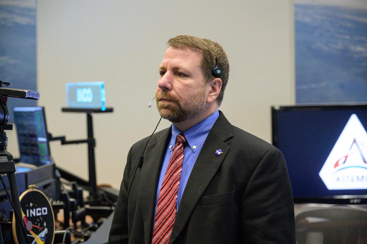 jsc2022e090746 (Dec. 1, 2022): Flight controller Todd Quasny at the command and data handling console in Houston’s Mission Control Center observes the Orion spacecraft under the direction of Flight Director Rick LaBrode. The spacecraft departed its distant retrograde orbit on flight day 16 of the Artemis I mission – one of the steps needed to bring the spacecraft home from the Moon. Credit: NASA/Robert Markowitz