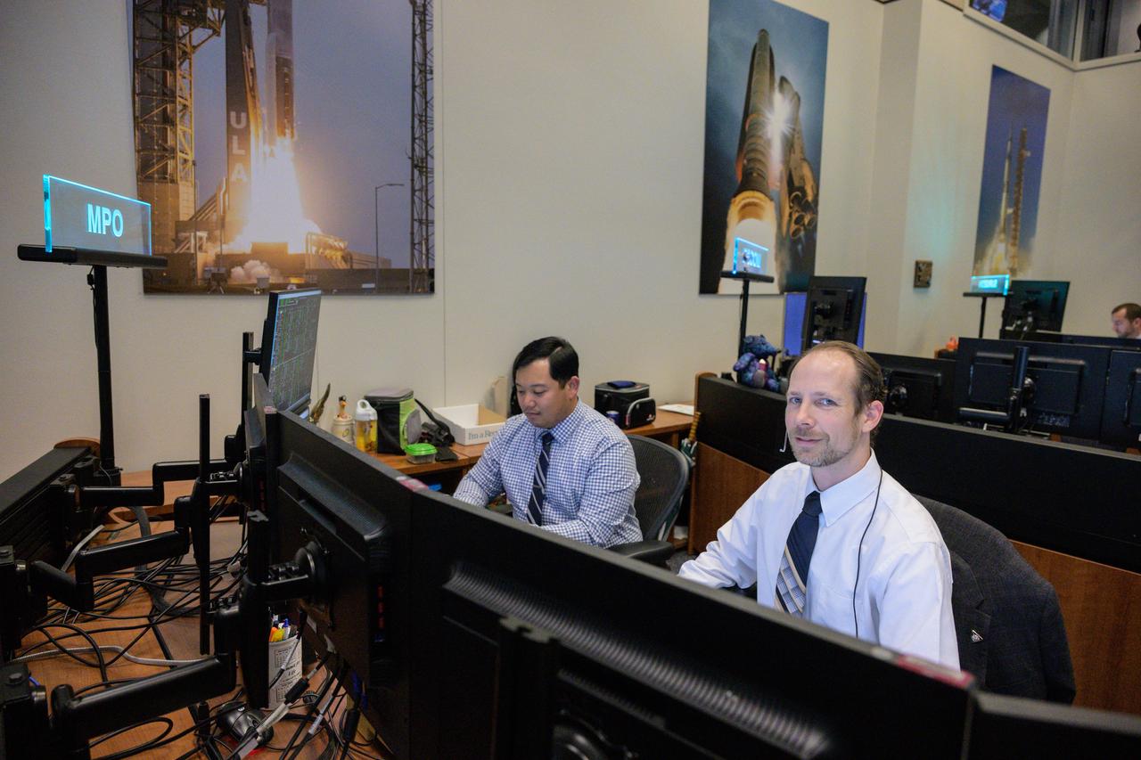 jsc2022e090747 (Dec. 1, 2022): Flight controllers Doug Haskovec and Amar Ollero at the mechanical and power officer console in Houston’s Mission Control Center observe the Orion spacecraft under the direction of Flight Director Rick LaBrode. The spacecraft departed its distant retrograde orbit on flight day 16 of the Artemis I mission – one of the steps needed to bring the spacecraft home from the Moon. Credit: NASA/Robert Markowitz