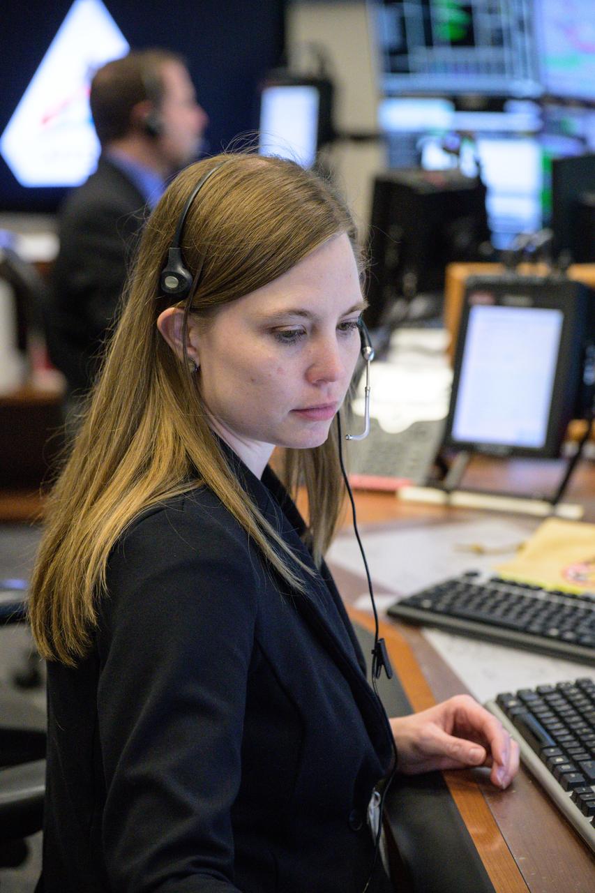 jsc2022e090753 (Dec. 1, 2022): Flight controller Julie Reed at the flight dynamics officer console in Houston’s Mission Control Center observes the Orion spacecraft under the direction of Flight Director Rick LaBrode. The spacecraft departed its distant retrograde orbit on flight day 16 of the Artemis I mission – one of the steps needed to bring the spacecraft home from the Moon. Credit: NASA/Robert Markowitz