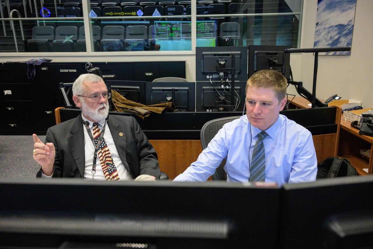 jsc2022e090759 (Dec. 1, 2022): Flight controllers Steve Sides and Brian Crisp at the instrumentation and communications officer console in Houston’s Mission Control Center observe the Orion spacecraft under the direction of Flight Director Rick LaBrode. The spacecraft departed its distant retrograde orbit on flight day 16 of the Artemis I mission – one of the steps needed to bring the spacecraft home from the Moon. Credit: NASA/Robert Markowitz