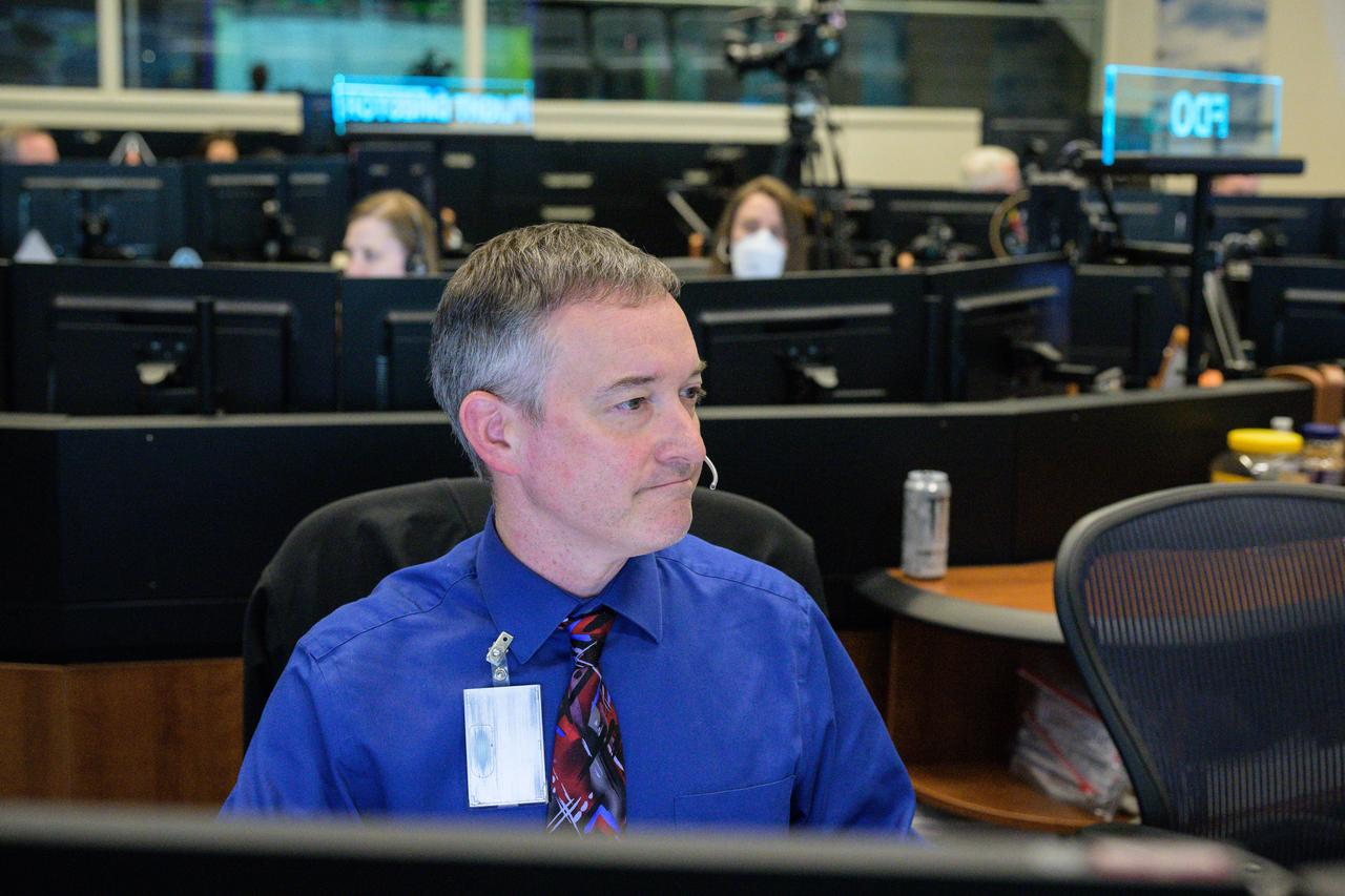 jsc2022e090764 (Dec. 1, 2022): Flight controller Jason Helms at the guidance, navigation and control console in Houston’s Mission Control Center observes the Orion spacecraft under the direction of Flight Director Rick LaBrode. The spacecraft departed its distant retrograde orbit on flight day 16 of the Artemis I mission – one of the steps needed to bring the spacecraft home from the Moon. Credit: NASA/Robert Markowitz