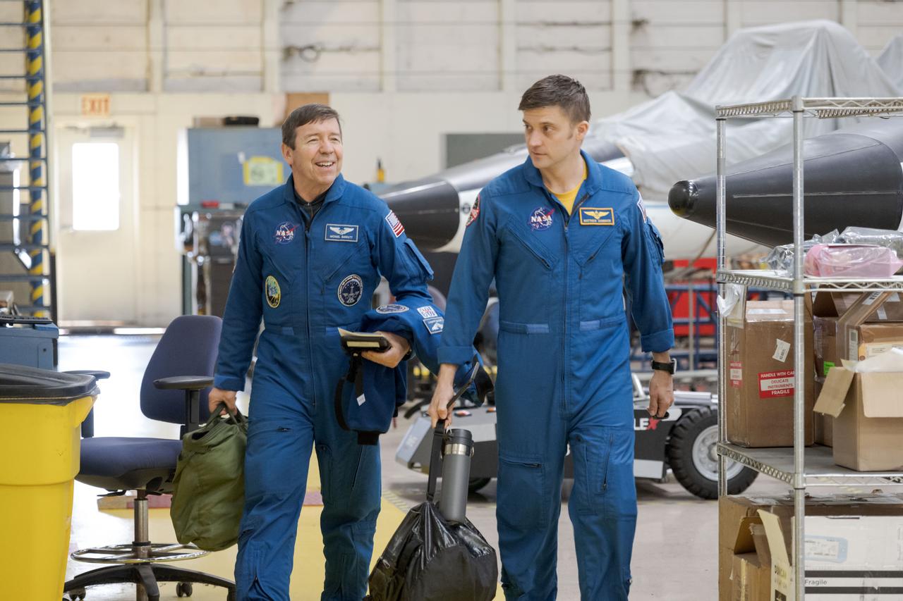 jsc2023e005072 (Jan. 25, 2023) --- NASA astronauts (from left) Mike Barratt and Matthew Dominick, SpaceX Crew-8 Pilot and Commander respectively, walk together before a T-38 trainer jet flight at Ellington Field.