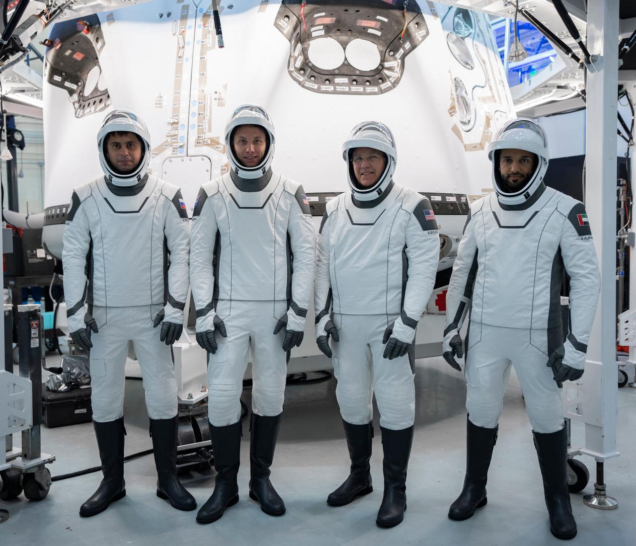 jsc2023e005748 (Jan. 30, 2023) --- The four crew members that comprise the SpaceX Crew-6 mission are pictured in front of the SpaceX Dragon crew ship during a crew equipment integration test at the company's headquarters in Hawthorne, California. From left, in their pressure suits are, Mission Specialist Andrey Fedyaev of Roscosmos; Pilot Warren "Woody" Hoburg and Commander Stephen Bowen, both from NASA; and Mission Specialist Sultan Alneyadi from the Mohammed bin Rashid Space Centre. Credit: SpaceX