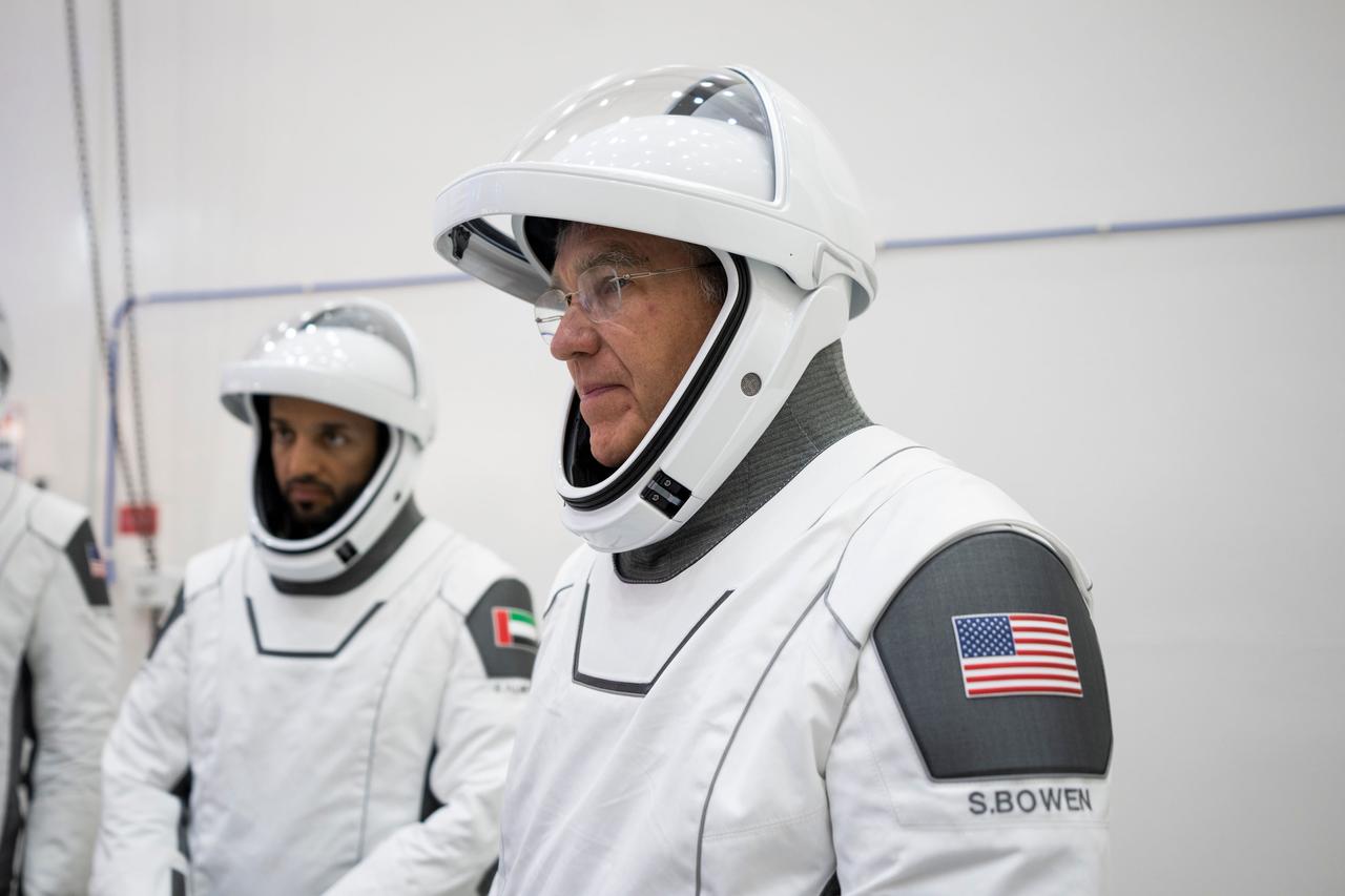 jsc2023e005755 (Jan. 30, 2023) --- Astronaut Stephen Bowen of NASA's Commercial Crew Program, SpaceX Crew-6 Commander, is pictured in his pressure suit during a crew equipment integration test at SpaceX headquarters in Hawthorne, California. In the background, is astronaut Sultan Alneyadi from the Mohammed bin Rashid Space Centre, SpaceX Crew-6 Mission Specialist. Credit: SpaceX
