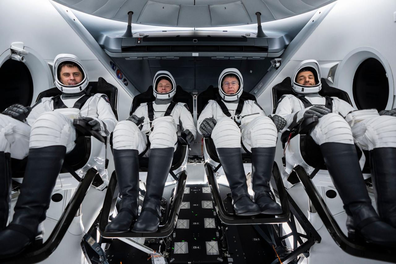 jsc2023e005758 (Jan. 30, 2023) --- The four crew members that comprise the SpaceX Crew-6 mission are seated inside the SpaceX Dragon crew ship during a crew equipment integration test at SpaceX headquarters in Hawthorne, California. Seated from left in their pressure suits are, Mission Specialist Andrey Fedyaev of Roscosmos; Pilot Warren "Woody" Hoburg and Commander Stephen Bowen, both from NASA; and Mission Specialist Sultan Alneyadi from the Mohammed bin Rashid Space Centre. Credit: SpaceX