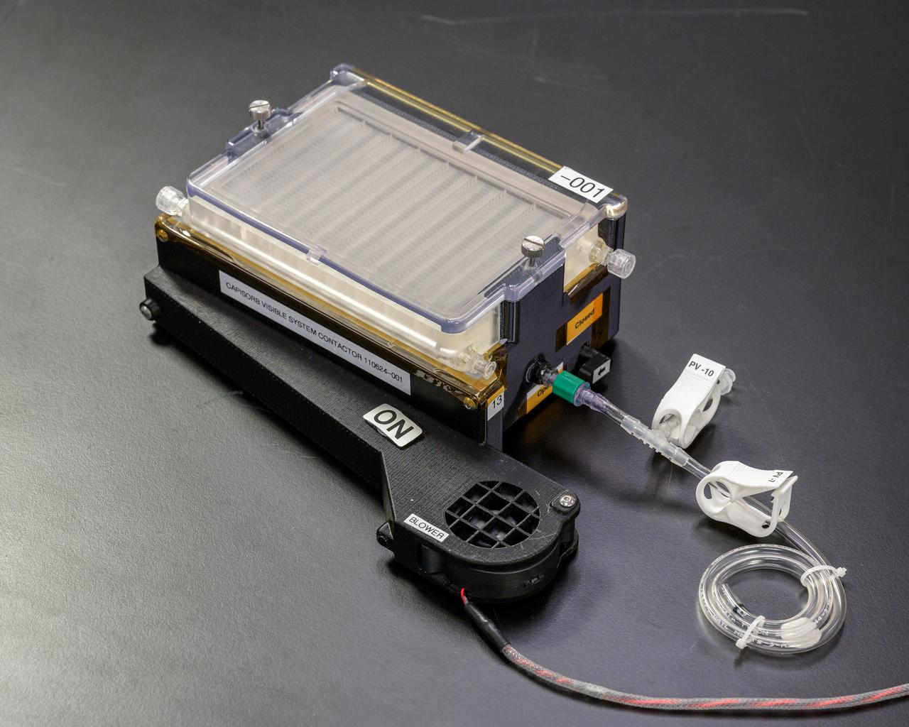 jsc2023e010168 (1/30/2023) --- CapiSorb Visible System flight unit contactor in N240 room 133B. The CapiSorb Visible System will be launched on SpaceX CRS-27 in March 2023 to the International Space Station to demonstrate a liquid sorbent-based system that leverages the advantages of liquid control through capillary action to remove carbon dioxide from crewed atmospheres...Capillary wedges in the CapiSorb Visible System Contactor, shown here preflight, control and passively transport viscous liquid in microgravity in order to demonstrate capabilities needed for future liquid carbon dioxide removal technologies. The CapiSorb Visible System investigation demonstrates a liquid control using capillary forces, over a range of properties that are characteristic of liquids which absorb carbon dioxide. Image courtesy of NASA's Ames Research Cente