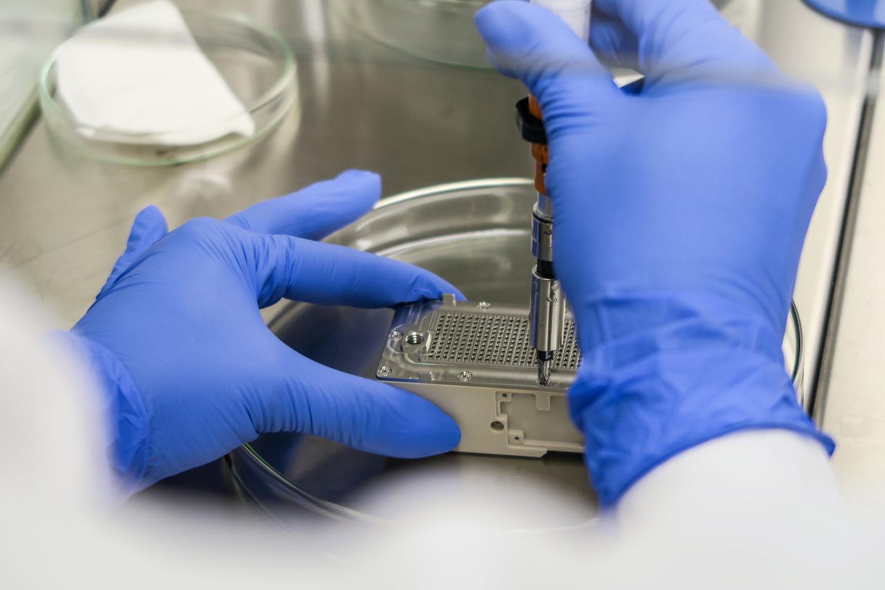 jsc2023e010176 (8/21/2021) --- This image shows the final step of assembling the ESA-Biofilms experiment unit. Inside the experiment unit, growth of the bacterial model organisms is supported under controlled conditions on different antimicrobial surfaces. The ESA-Biofilms investigation studies bacterial biofilm formation and antimicrobial properties of different metal surfaces under spaceflight conditions in altered gravity. Image courtesy of DLR, CC BY-NC-ND 3.0.