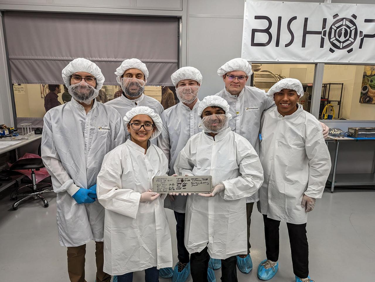 jsc2023e010190  (12/13/2022) --- LightCube team members inspect the CubeSat prior to integration into the deployer. From left to right: David Ordaz Perez, Chandler Hutchens, Sam Cherian, Christopher McCormick, Ashley Lepham, Raymond Barakat. Image courtesy of Jaime Sanchez de la Vega.